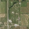 Grass fire near equipment and barns on East 160th Street