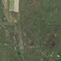 Grass fire in pasture near booster plant