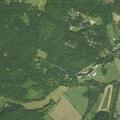 Person throwing tree debris toward trailhead