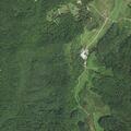 Person trapped under heavy object on farm
