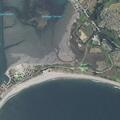 Swimmer reported in the water at Doran Beach; lifeguard en route