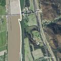 Teen male sitting on guardrail on highway overpass