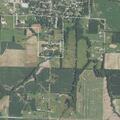 Farm equipment partially blocking roadway on Route V