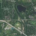Masked driver points gun with laser at park entrance