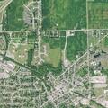 Person experiencing back pain near Sycamore Street