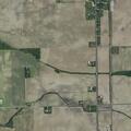 Truck losing gravel onto roadway and nearby vehicle in Urbana