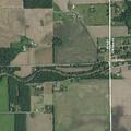 Traffic stop on silver car near covered bridge