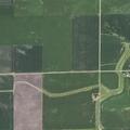 Combine smoldering in waterway near rural Dana