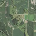 Brush pile fire near skid loader at rural property