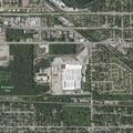Suspicious man walking toward gray Toyota sedan