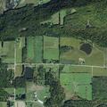 Car crash into field with smoking vehicle