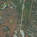 Ongoing alarm noise near River Road wooded area
