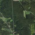 Suspicious vehicle spotlighting fields near lake