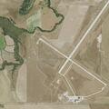 Officer checks juvenile lying on airport ramp
