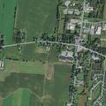 Person lying by grave at Avon cemetery