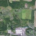 Man with severe ankle bleeding at industrial site parking lot