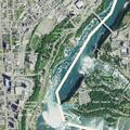 Woman possibly on edge of falls at Niagara in red jacket