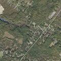 Male with ripped shirt on sidewalk near Ricker Road