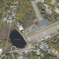 Injured deer near airport runway causing traffic risk
