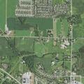 Brush fire smoldering in vacant lot in Greenville