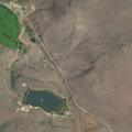 Wildland fire with active ground burning near ranch