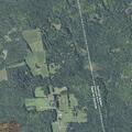 Grass fire spreading into woods in Corinna