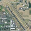 Female patient on oxygen arrives at airport hangar