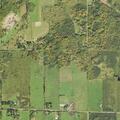 Lawnmower fire in field near metal fence