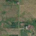 Small grass fire next to combine in field
