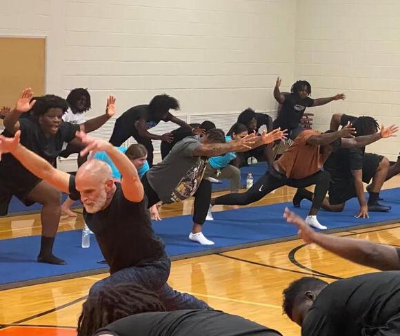 NFL players connect with Carver football team through yoga
