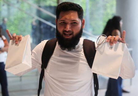 'Truly something cool': Apple fans react as iPhone Duo hits stores ...