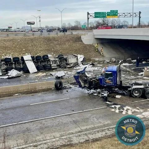 Semi-truck crashes through I-94 guard rail, flips onto Merriman Road ...