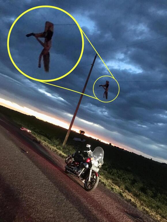 Mindbending photo shows teen dangling from a power line after being