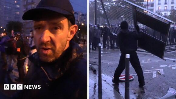 Fireworks and tear gas as protesters and riot police clash in Paris