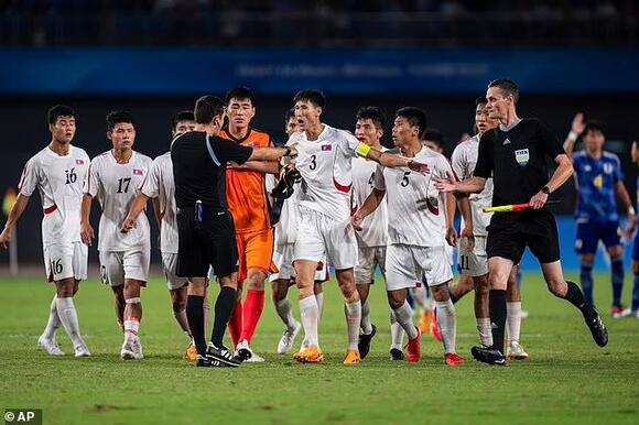 North Korean players ATTACK the referee after their 2-1 defeat by Japan in  Asian Games quarter finals, with the official surrounded and shoved in  heated scenes