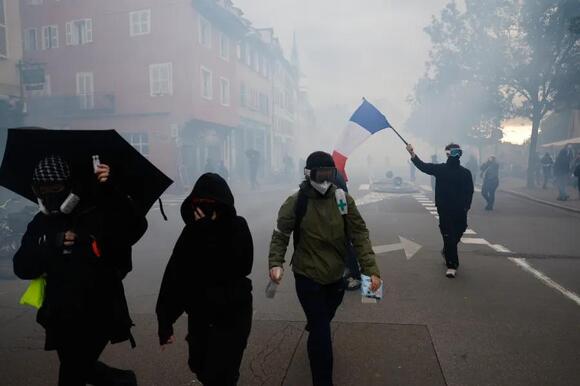 More than 400,000 protest across France, challenging Macron as Paris clashes erupt
