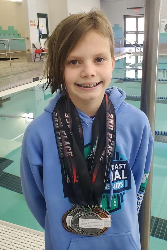 YMCA Dolphins swim team member competes in Regional Meet