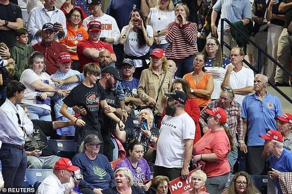 Trump rally derailed by series of protesters in opening minutes as he unleashes on Graham's opponent
