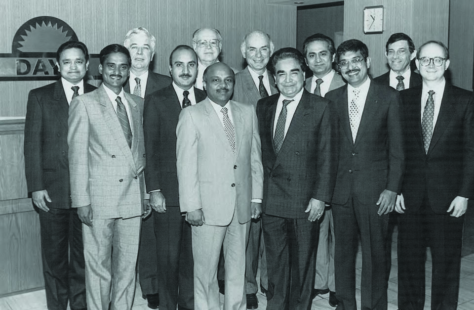 Gujarati immigrants, a community building a hotel legacy, pose for a group photo.