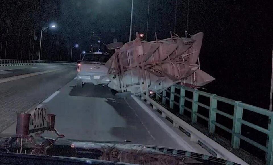Gust of wind causes a canoe trailer to tip over on the Mackinac Bridge ...