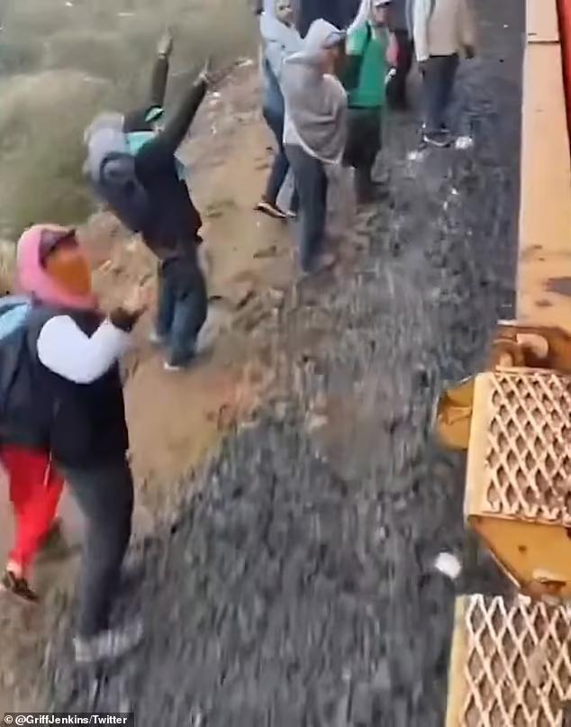 Shocking moment THOUSANDS of migrants line train track in Mexico, three ...