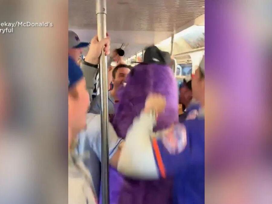 CAUGHT ON CAMERA Baseball fans excited to catch a train with Grimace