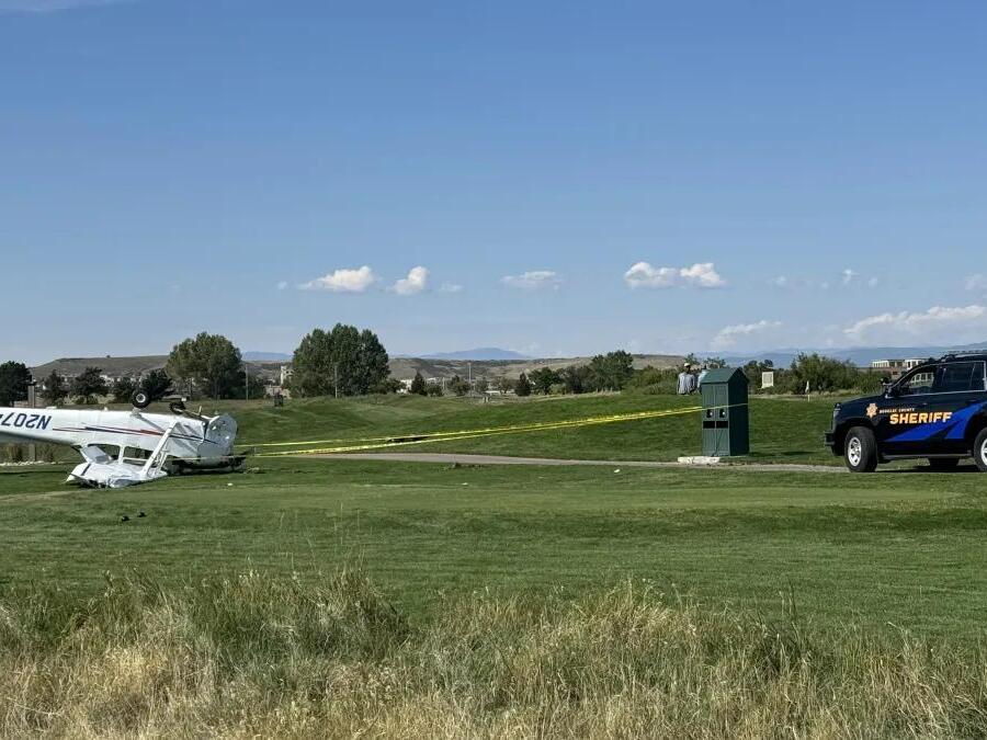 2 people walk away after a small plane crashes and lands upside down at