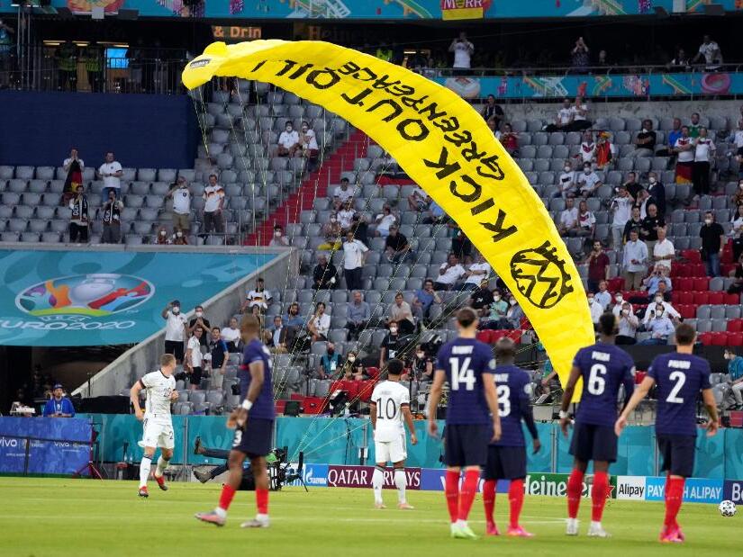 Germany vs. France: 'Kick out oil' protester parachutes ...