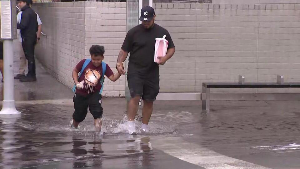 New Yorkers wade through ankle-deep water in Brooklyn flash flood