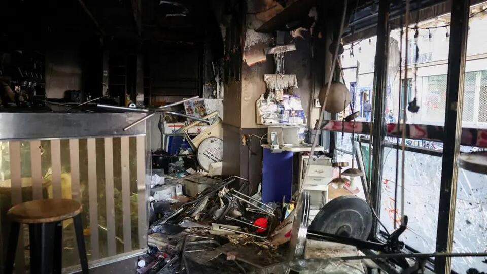 Burnt out cars and shattered glass on Paris streets after protests turn ...