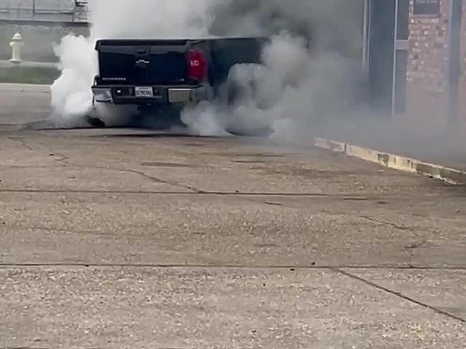 Truck catches on fire after crashing into building, officials say
