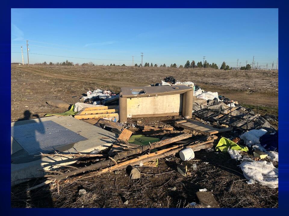 Police and local church clean up abandoned trash pile in Airway Heights