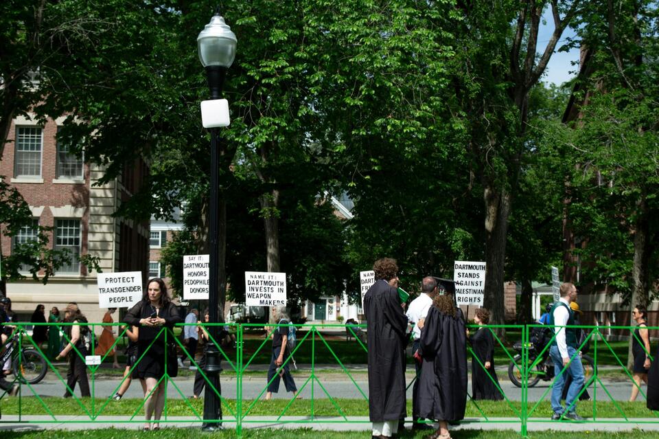 Silent protesters process around the Green during Commencement ceremony ...