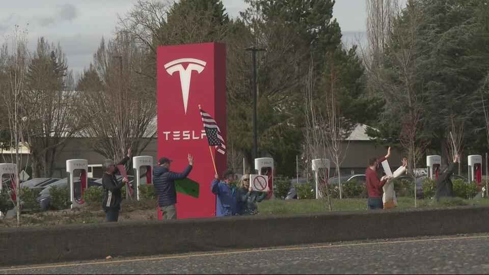 Protesters rally against Elon Musk outside Vancouver Tesla store ...